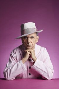 Kevin rowland sat with his head resting on his hands dressed all in pink