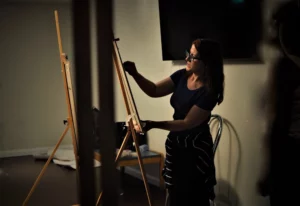 Irish Artist Sheila Moylan Painting in a Gallery