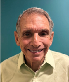 Potrait of Murray Rosenthal stood against a blue background