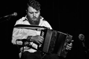 Will Allen playing the diatonic button accordion in black and white