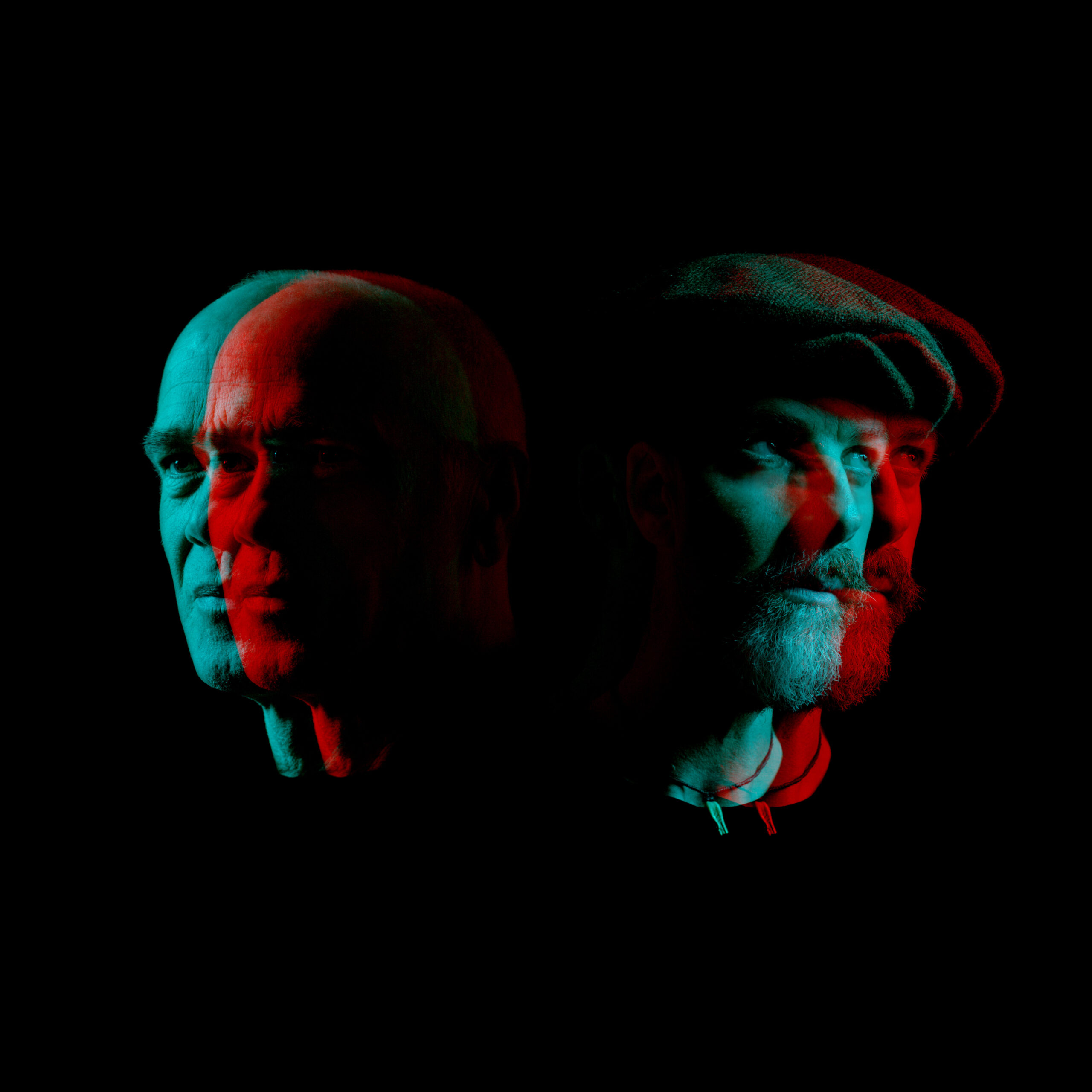 The heads of Irish musicians Rónán Ó Snodaigh and Myles O’Reilly as neon holograms on a black background facing away from eachother