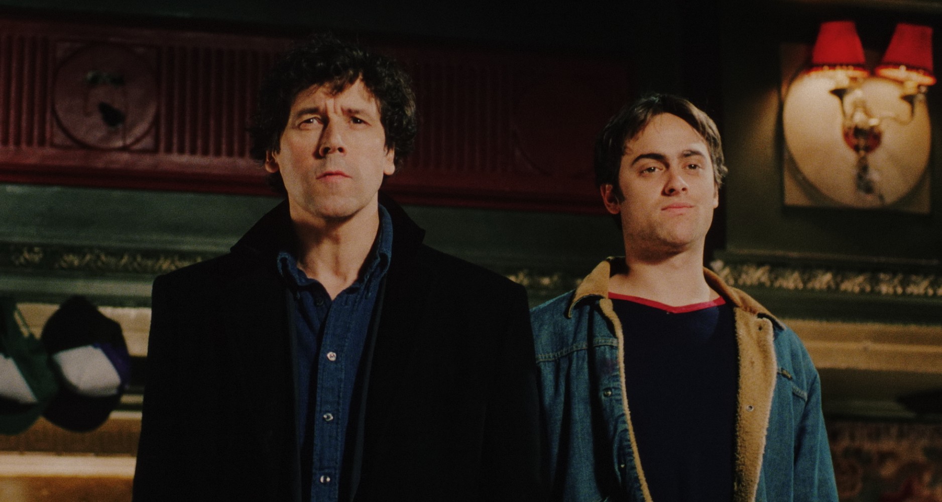 Two men standing in jackets facing camera